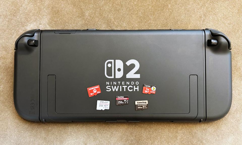 A collection of microSD Express cards rest on the back of a Nintendo Switch 2 gaming console.