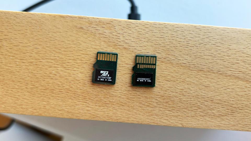 Unlike traditional UHS-I cards, a microSD Express card like the SanDisk model on the right comes with a second row of pins to enable its improved performance.