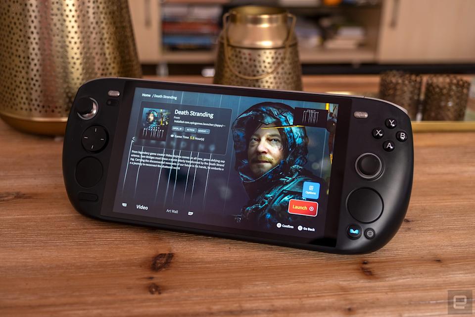 The Ayaneo Kun is pictured on a coffee table with the Death Stranding launch screen showing.