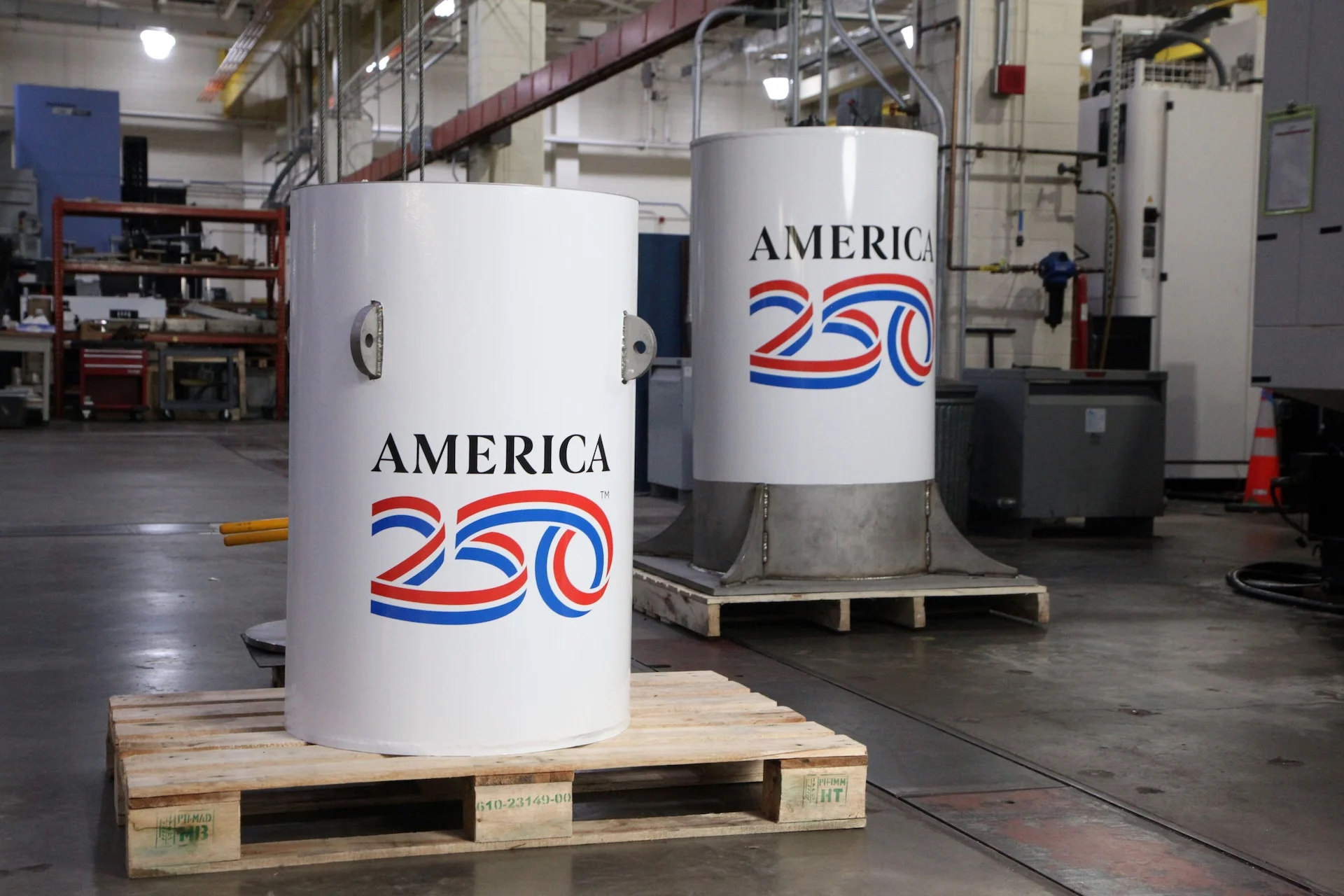 The America250 time capsule, left, and the bell jar that will fit on top of it, shown here in the machine shop where they were created at the National Institute of Standards and Technology (NIST) in Gaithersburg, Md.