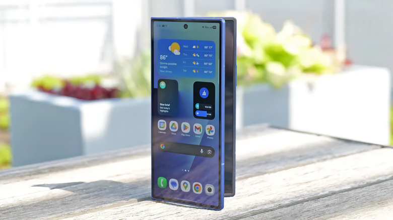 A blue Galaxy Z Fold 7 propped up vertically on a wooden table.